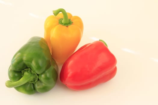 Different colored peppers isolated against neutral background