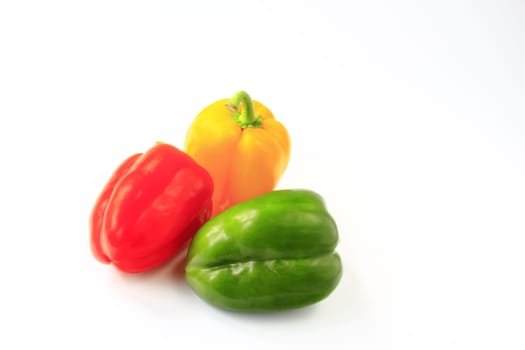 Different colored peppers isolated against neutral background