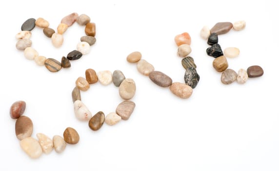 Love Sign Made of Pebbles on White Background
