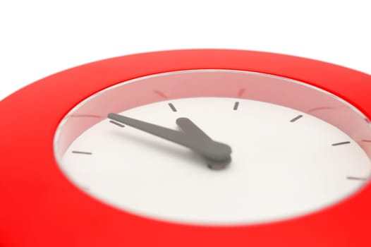 Detail of Red Wall Clock Showing Five To Midnight - Isolated on White