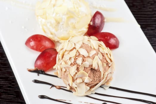 Dessert set of ice-cream with almond, chocolate and grapes