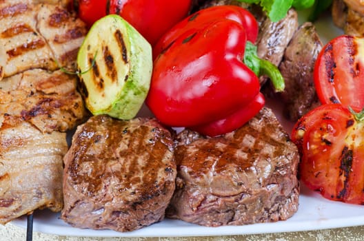BBQ meat with vegetables and greens closeup