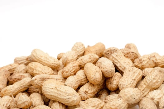 Closeup of Unpeeled Peanuts on White Background