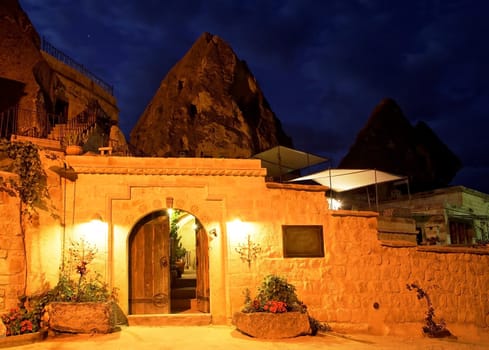 Limestone cave residence converted to a boutique hotel Goreme, Turkey. Night scene under street lights, horizontal landscape with crop area and copy space