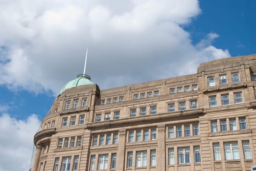 A Victorian Office Block with a Green Dome under a blue sky