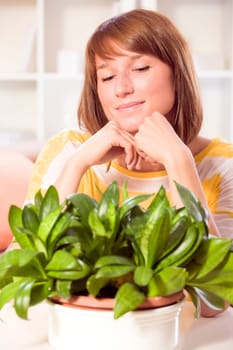young happy woman looking at plants