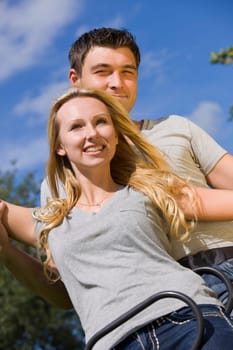 happy young couple on a swing outdoor