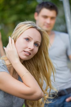 young couple outdoor - focus on female in foreground