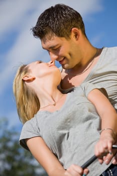 kissing couple on a swing outdoor