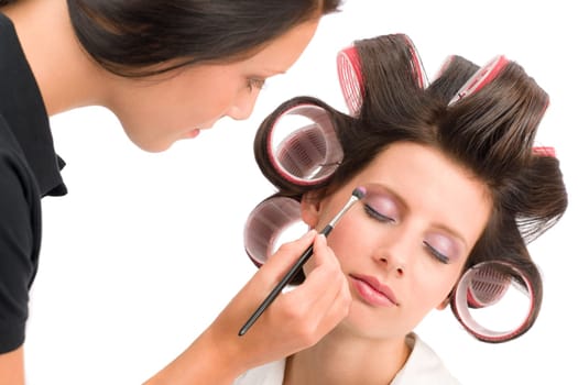 Make-up artist woman fashion model apply eyeshadow with brush