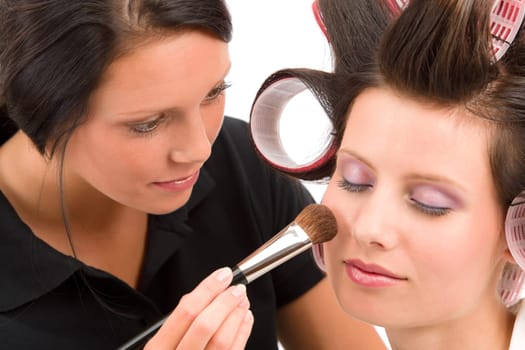 Make-up artist woman fashion model apply powder blush rouge brush