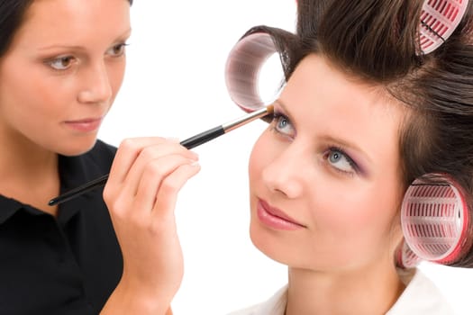 Make-up artist woman fashion model apply eyeshadow with brush