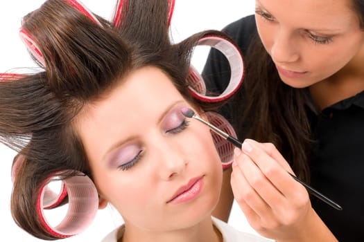 Make-up artist woman fashion model apply eyeshadow with brush