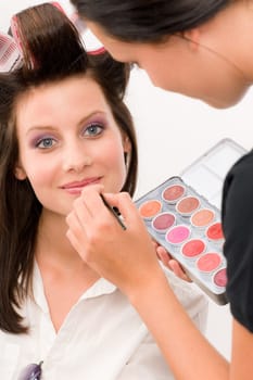 Make-up artist woman fashion model apply lipstick from color palette