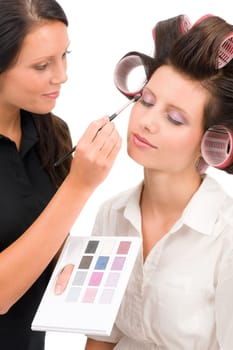Make-up artist woman fashion model apply eyeshadow from color palette