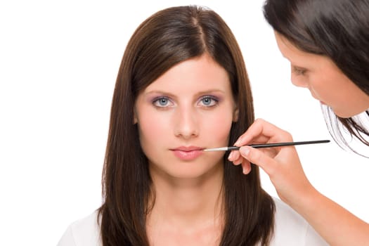 Professional makeup model portrait artist apply glossy lipstick using brush