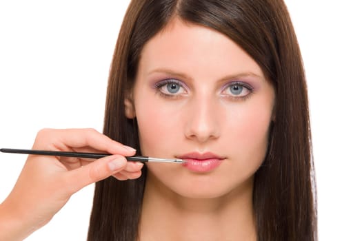 Professional makeup model portrait artist apply glossy lipstick using brush