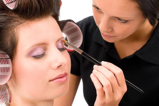 Make-up artist woman fashion model apply eyeshadow with brush