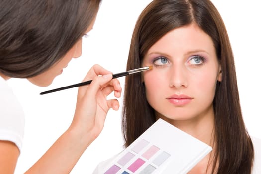 Make-up artist woman fashion model apply eyeshadow from color palette
