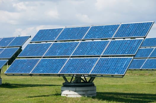 Photovoltaic system standing on a lawn on a cloudy day