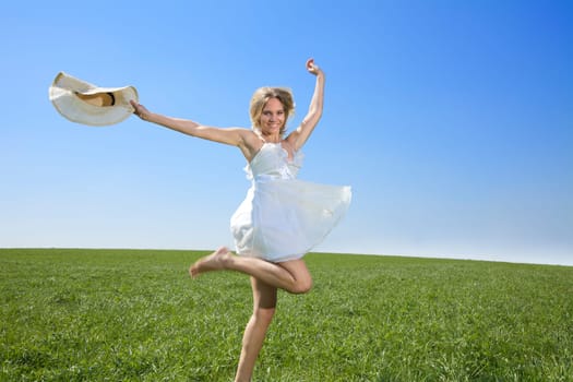 Young woman jumping / running in spring or summer