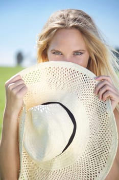 Young woman in spring or summer with straw hat