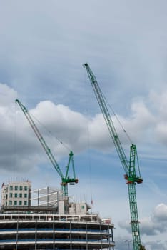 Two Green Tower Cranes a building under construction