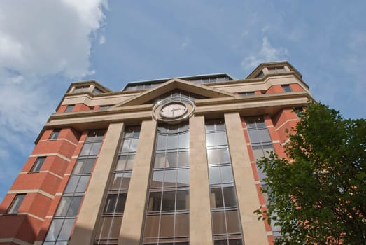 A Red Brick and Glass Office Block with Modern Clock