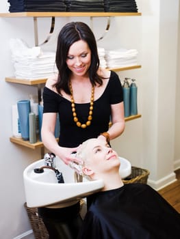 Hairdresser washing customers hair at a Beauty Spa