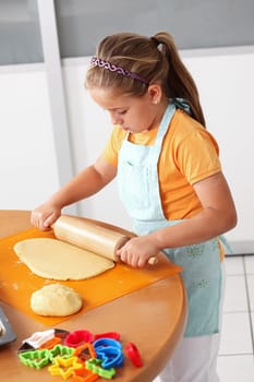 Cute girl baking cookies for Christmas