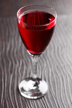 Glass of red wine on black background