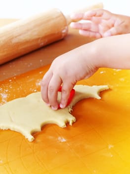 Detail of hands cutting pastry