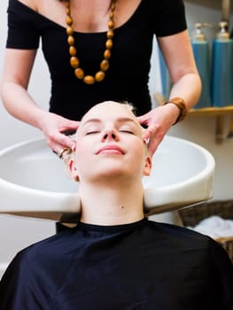 Hairdresser washing customers hair at a Beauty Spa