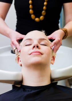 Hairdresser washing customers hair at a Beauty Spa