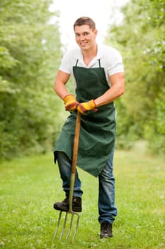 Young gardener with a compost fork