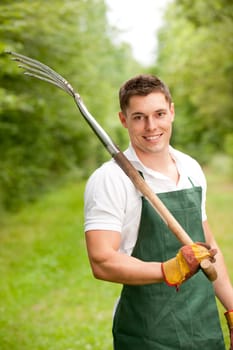 Young gardener with a compost fork