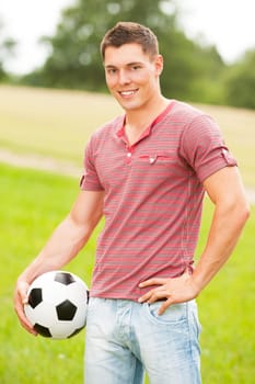 Young man in a park with soccer ball