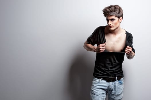 Fashion shot of a young man in the studio
