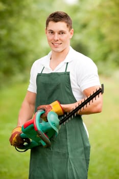 Young gardener with a hedge trimmer