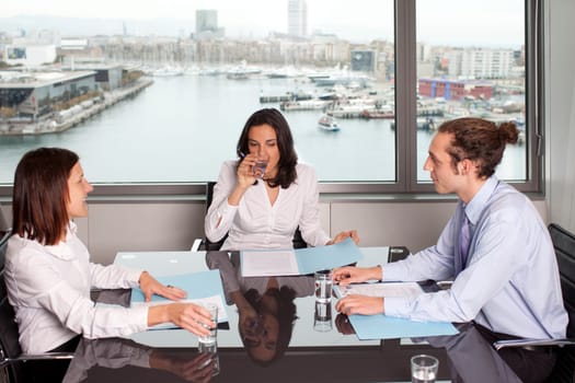 Woman drinking water during meeting