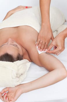 Woman with depilation of the armpit