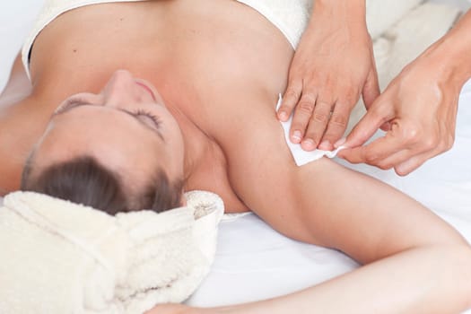 Woman with depilation of the armpit