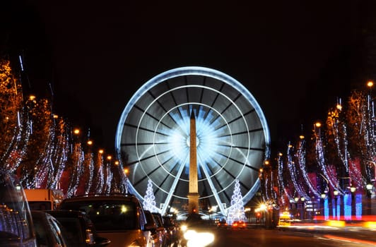 The Champs-Elysees avenue and the ferris wheel on Concorde Square illuminated for Christmas