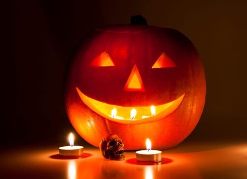Halloween lantern and a small skull lit by candles