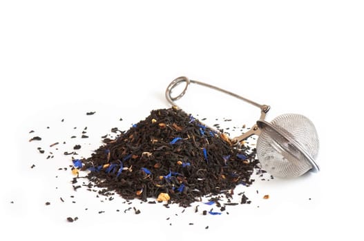 Scented tea and tea ball on white background