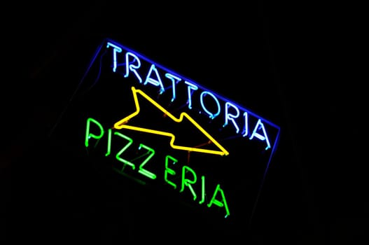 Trattoria and pizzeria neon sign in the night