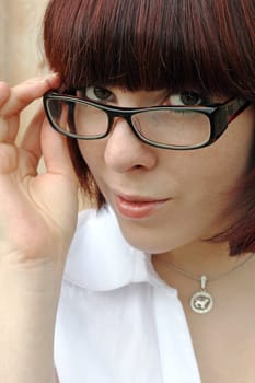 Erotic,stern look over the rim of the glasses