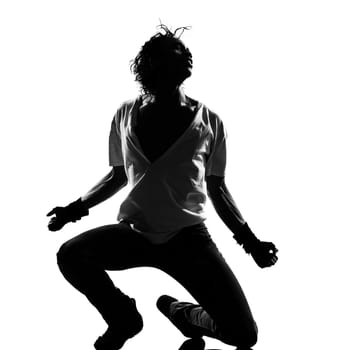 full length silhouette of a young man dancer dancing funky hip hop r&amp b on  isolated  studio white background