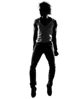 full length silhouette of a young man dancer dancing funky hip hop r&amp b on  isolated  studio white background