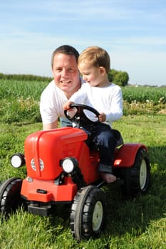 Father and son with red tractor